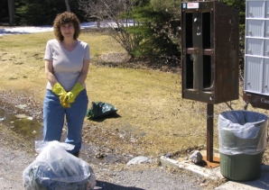 Kathy Derickx cleans up the mess around the postal boxes.